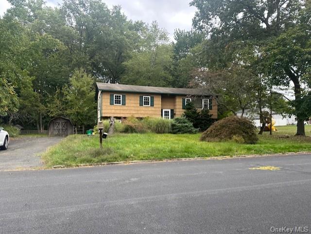 View of front of property featuring a storage unit