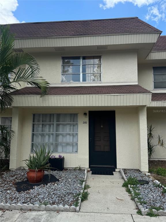 a front view of a house with plants