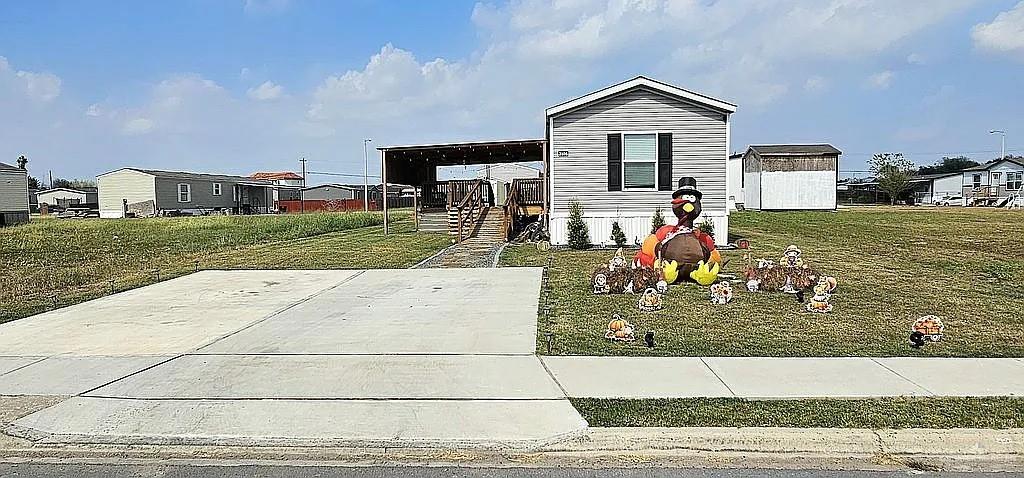 a view of a house with a yard in the background