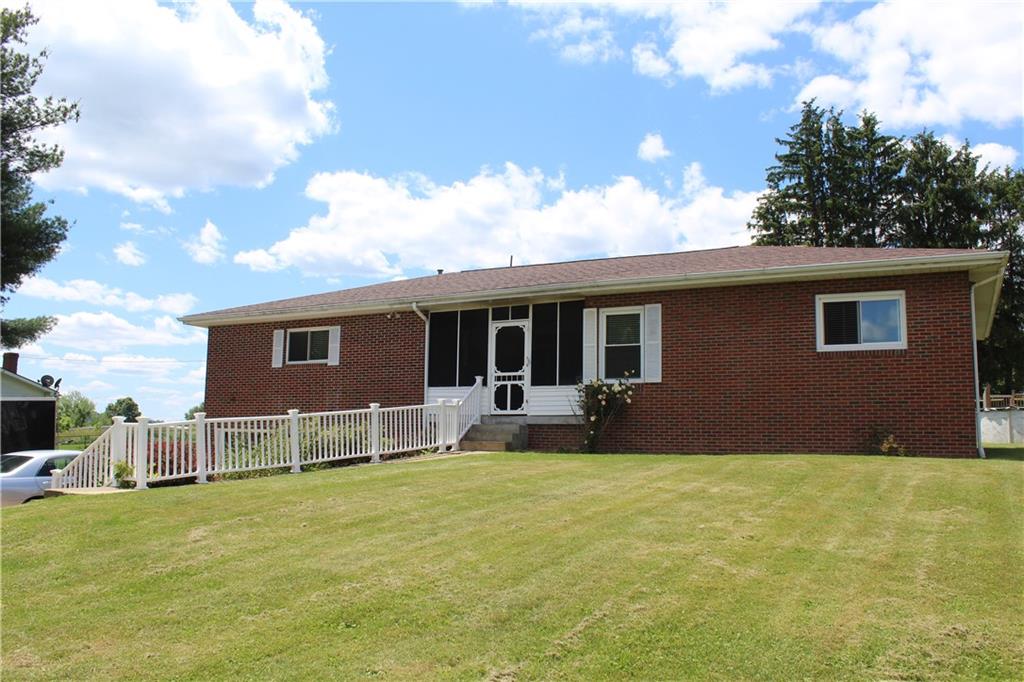 a front view of house with yard and seating area