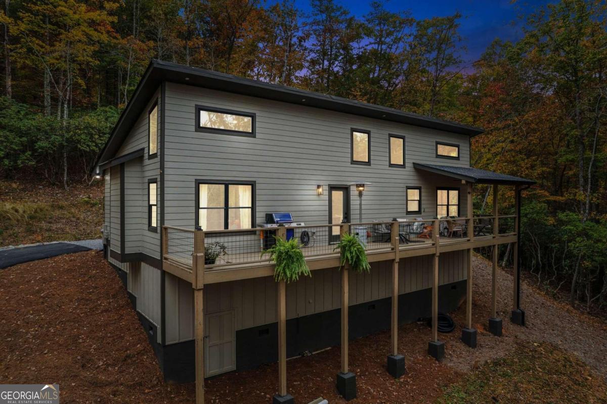 a backyard of a house with table and chairs