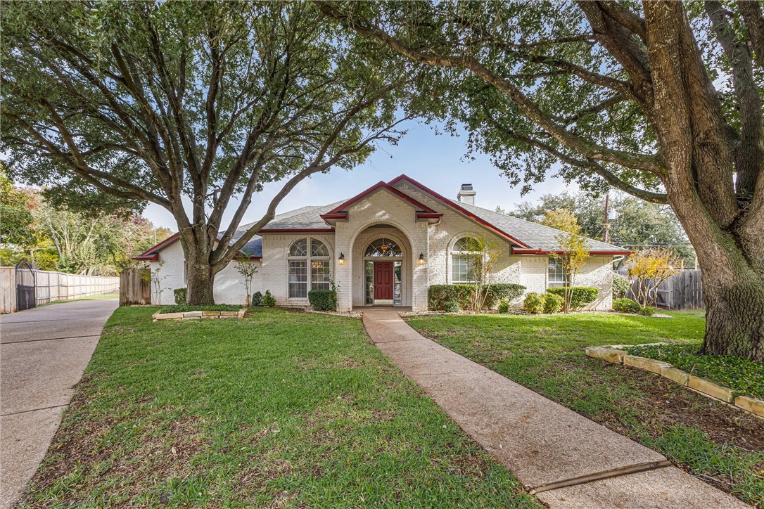 a front view of a house with yard and green space