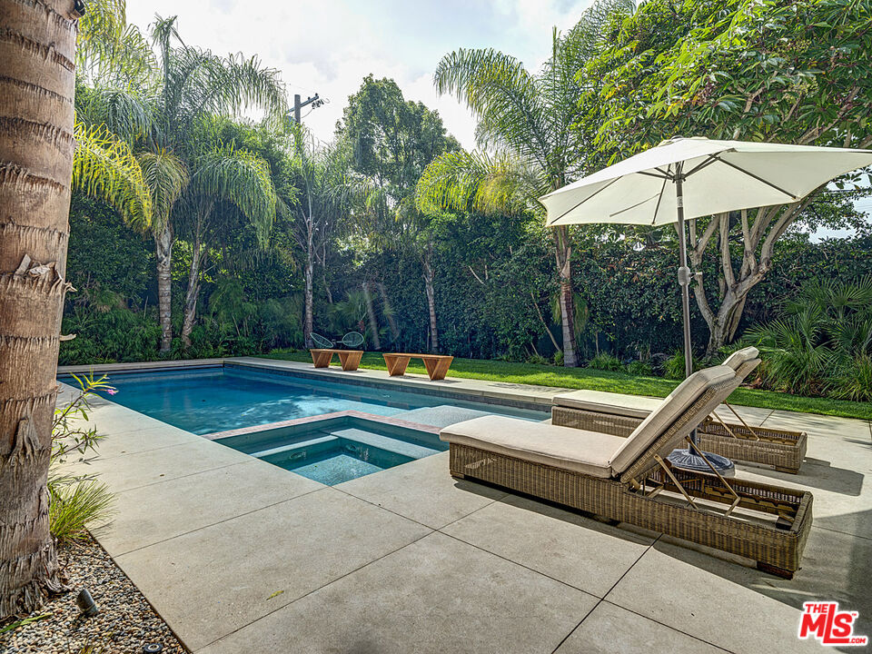 a view of swimming pool with chairs