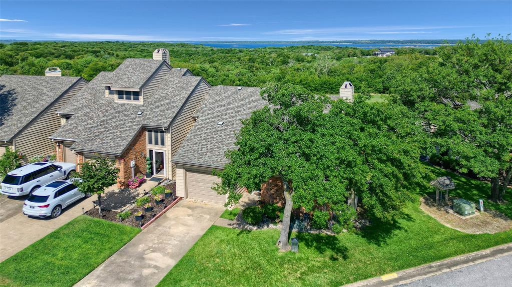 a aerial view of a house with garden space and a street view