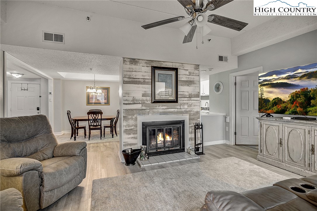 a living room with furniture and a fireplace