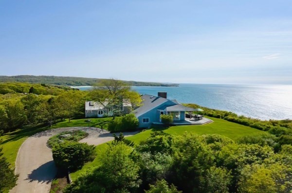 an aerial view of a house with a garden and lake view