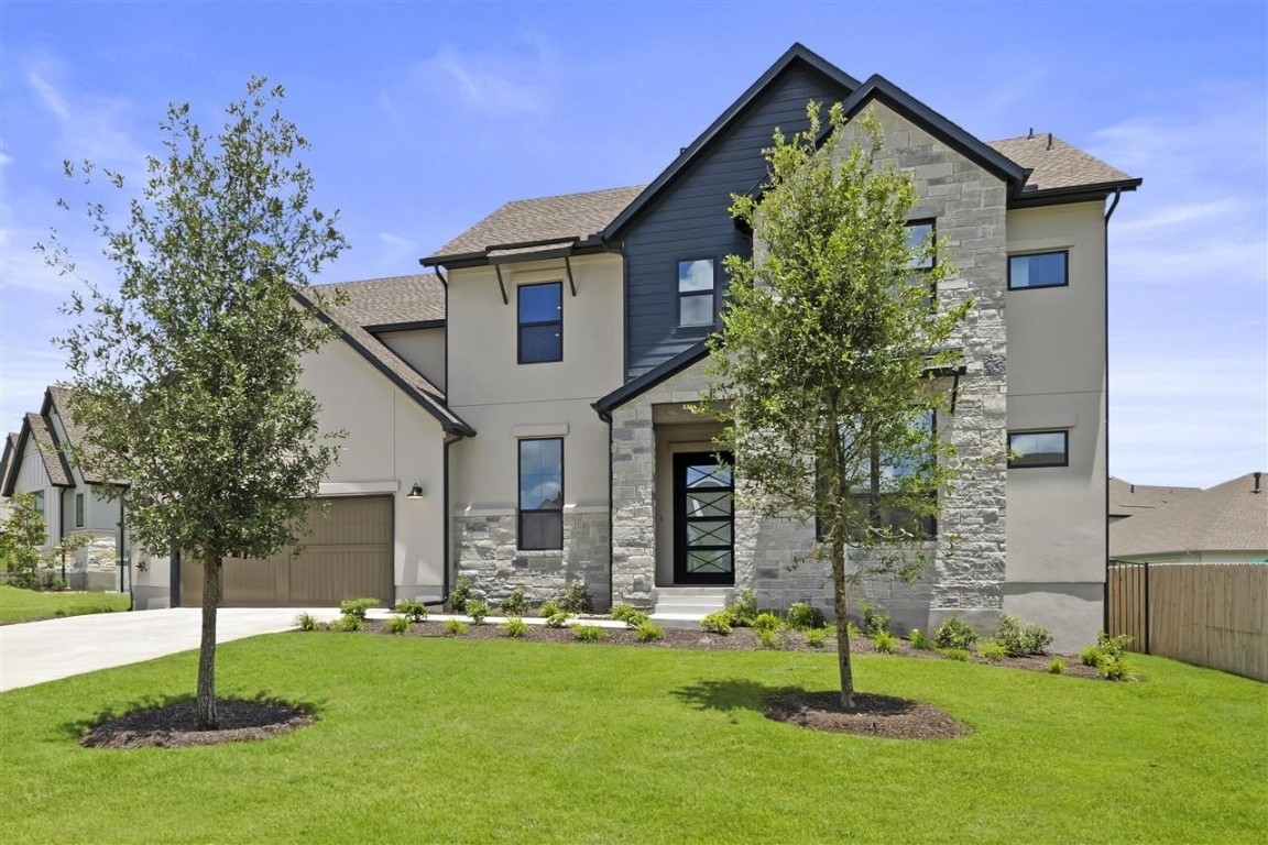 a front view of house with a garden