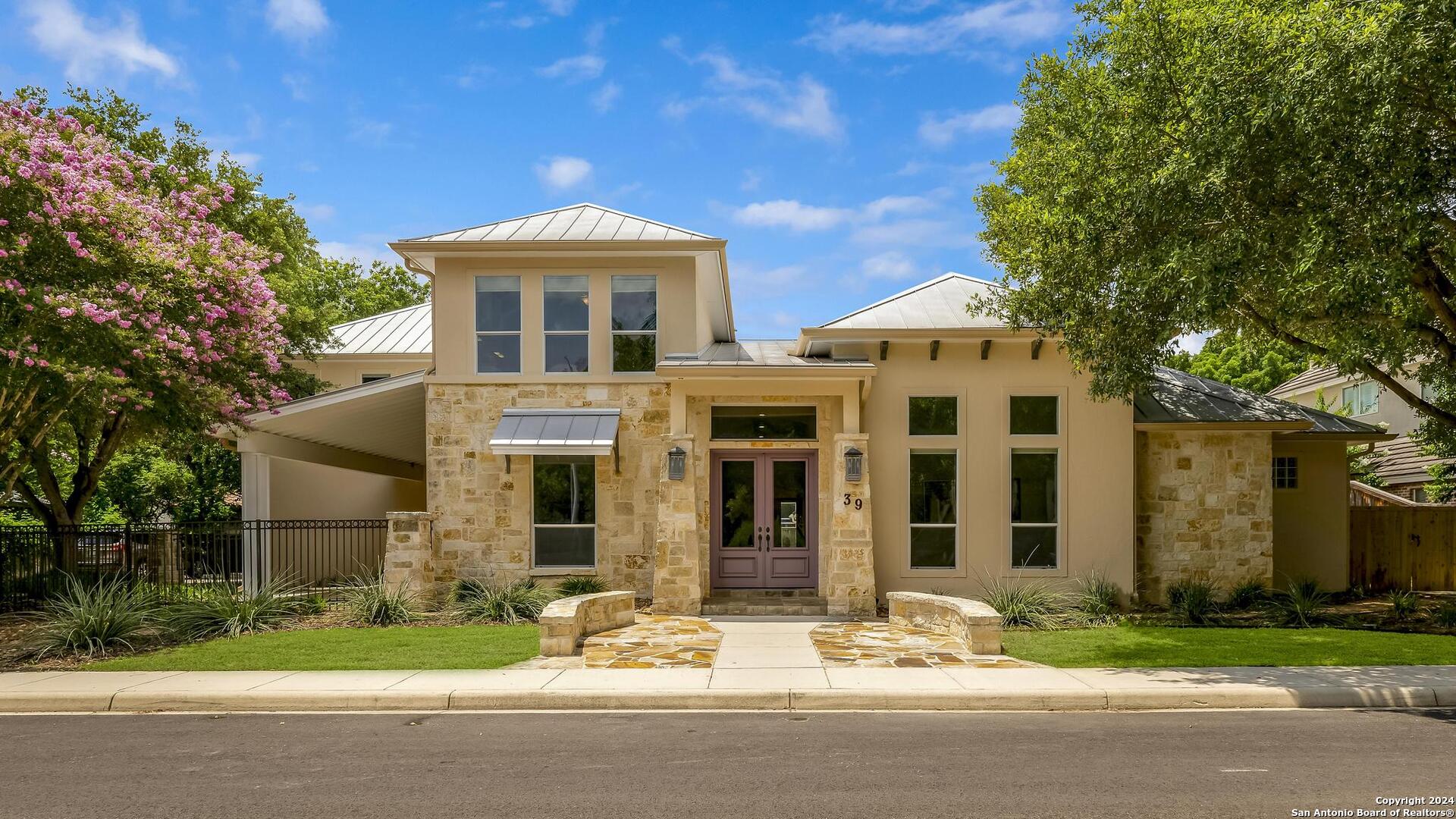 a front view of a house with a garden