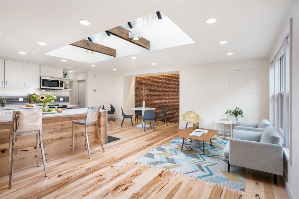 a living room with lots of furniture and kitchen view