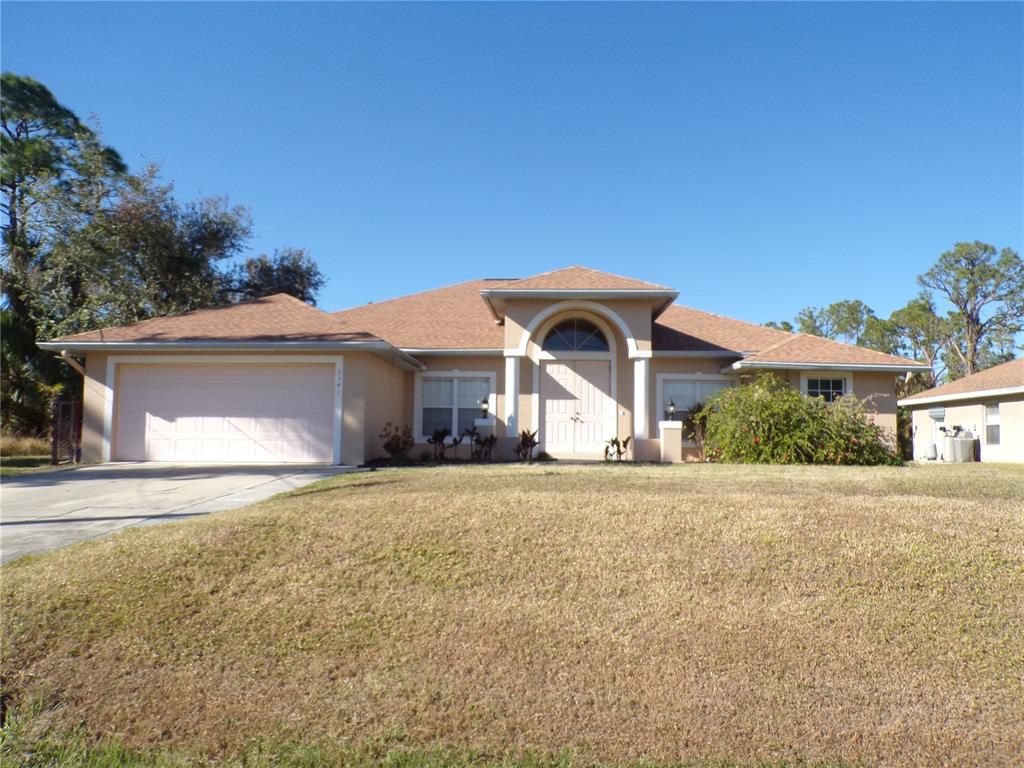 a front view of a house with a yard and garage