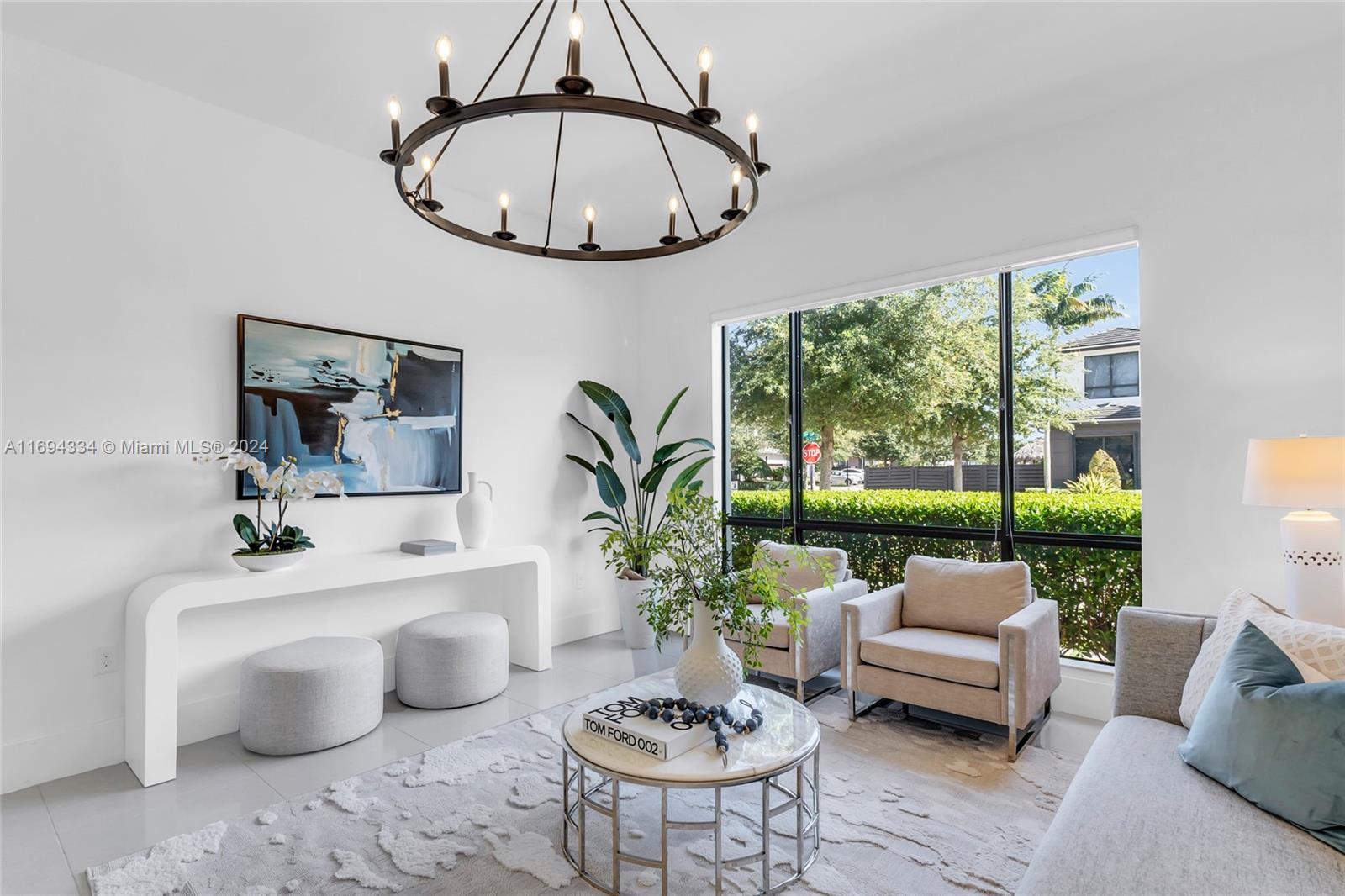 a living room with furniture a window and a chandelier