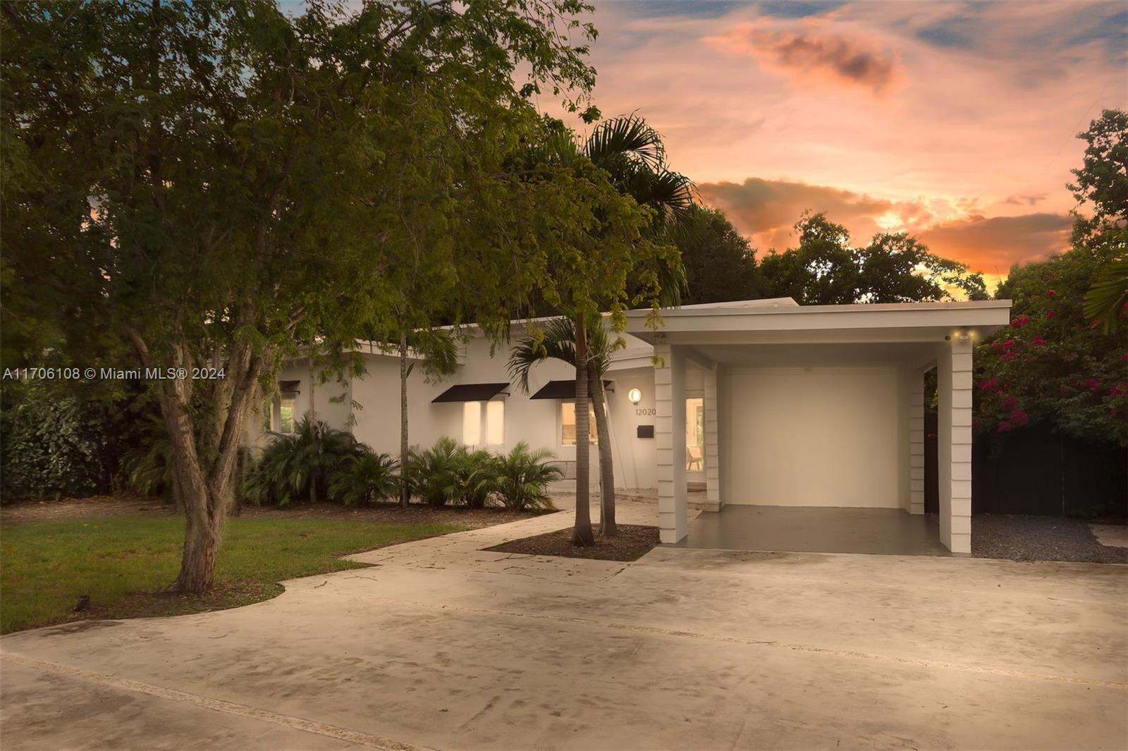 a view of a house with a yard and garage