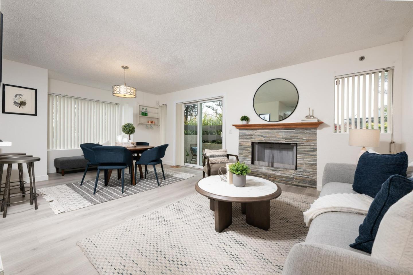 a living room with furniture a fireplace and a window