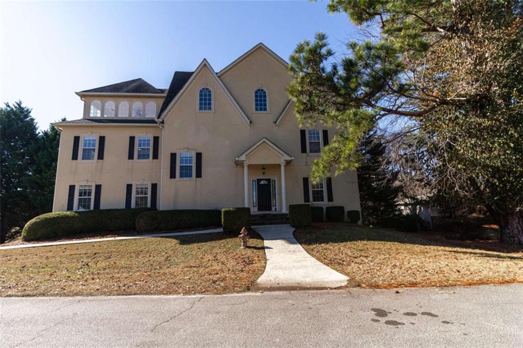 a front view of a house with a yard