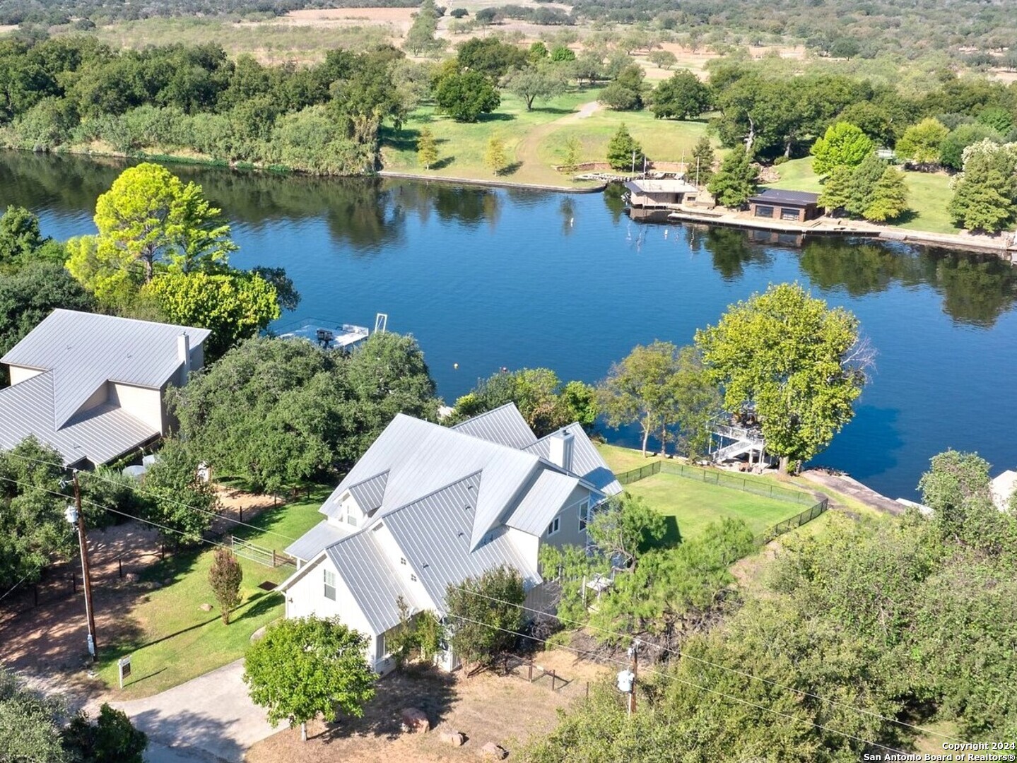 an aerial view of a house with a lake view