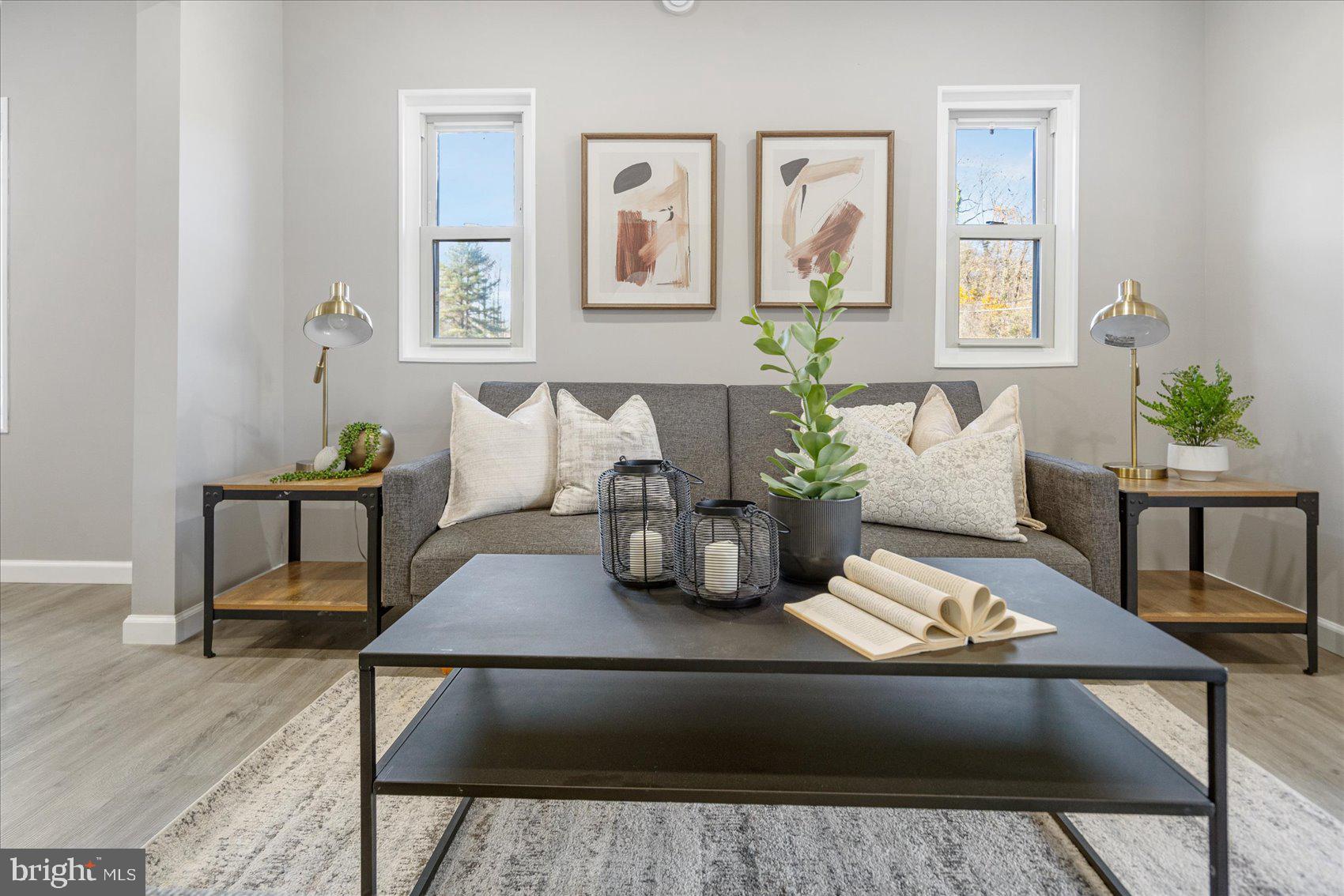 a living room with furniture and wooden floor