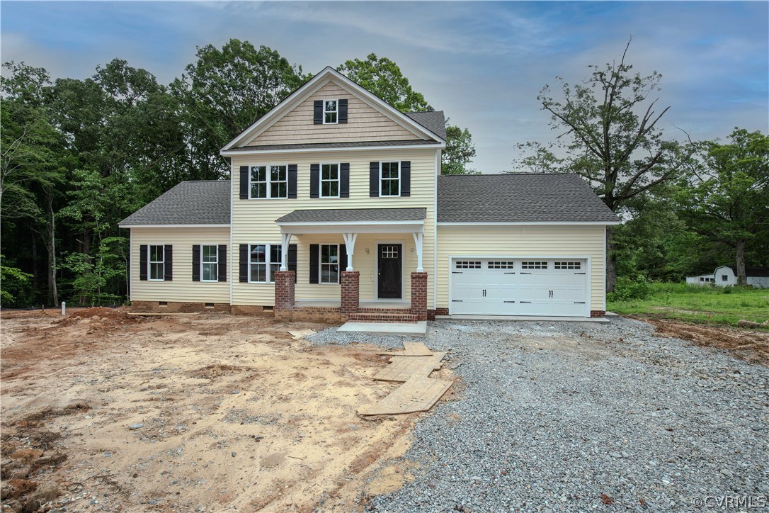 a front view of a house with a yard and trees