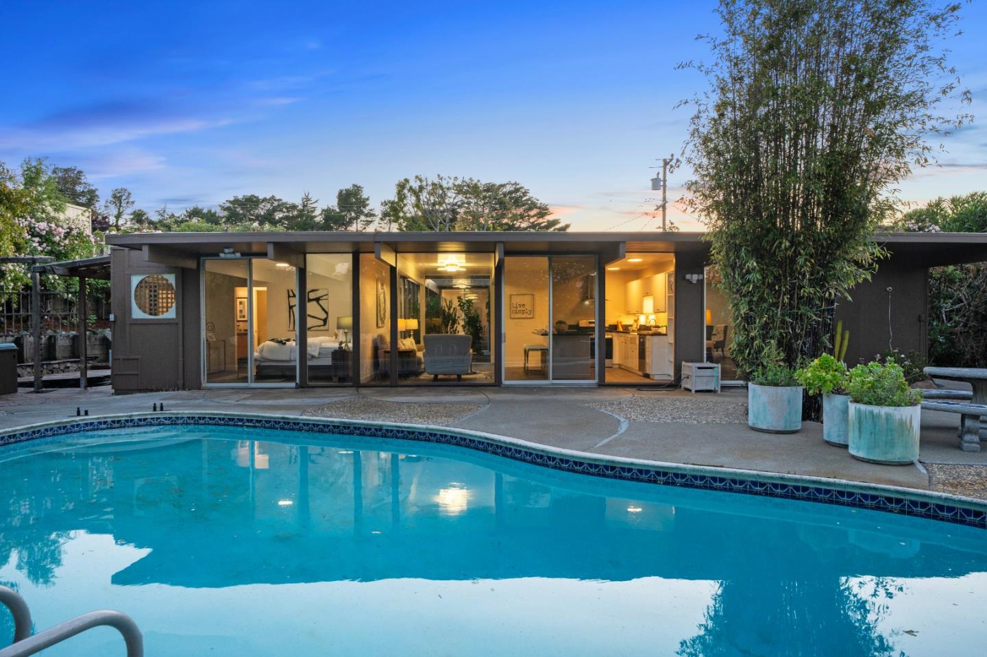 a view of a house with swimming pool and sitting area