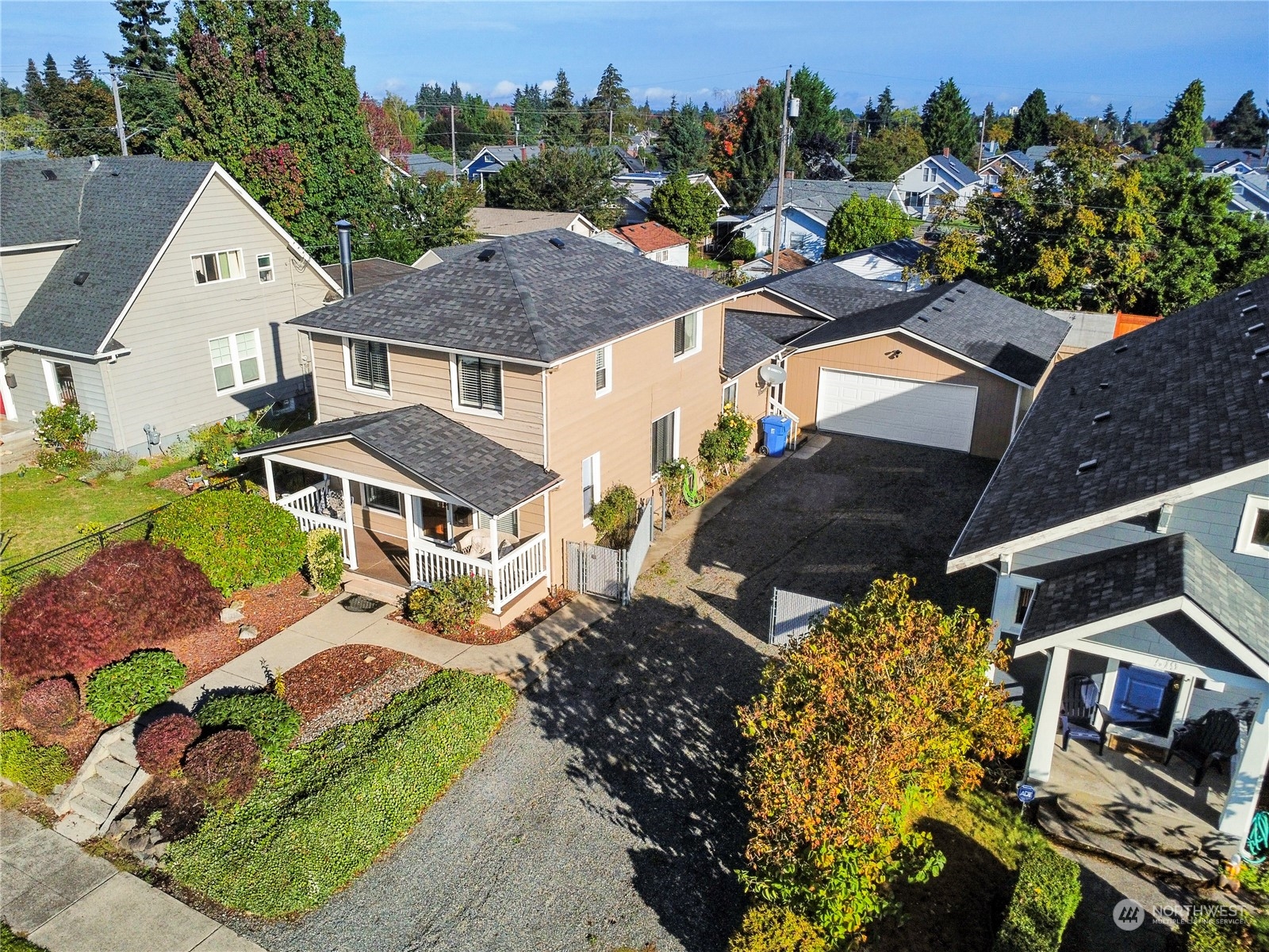 an aerial view of a house with a garden and mountain view in back