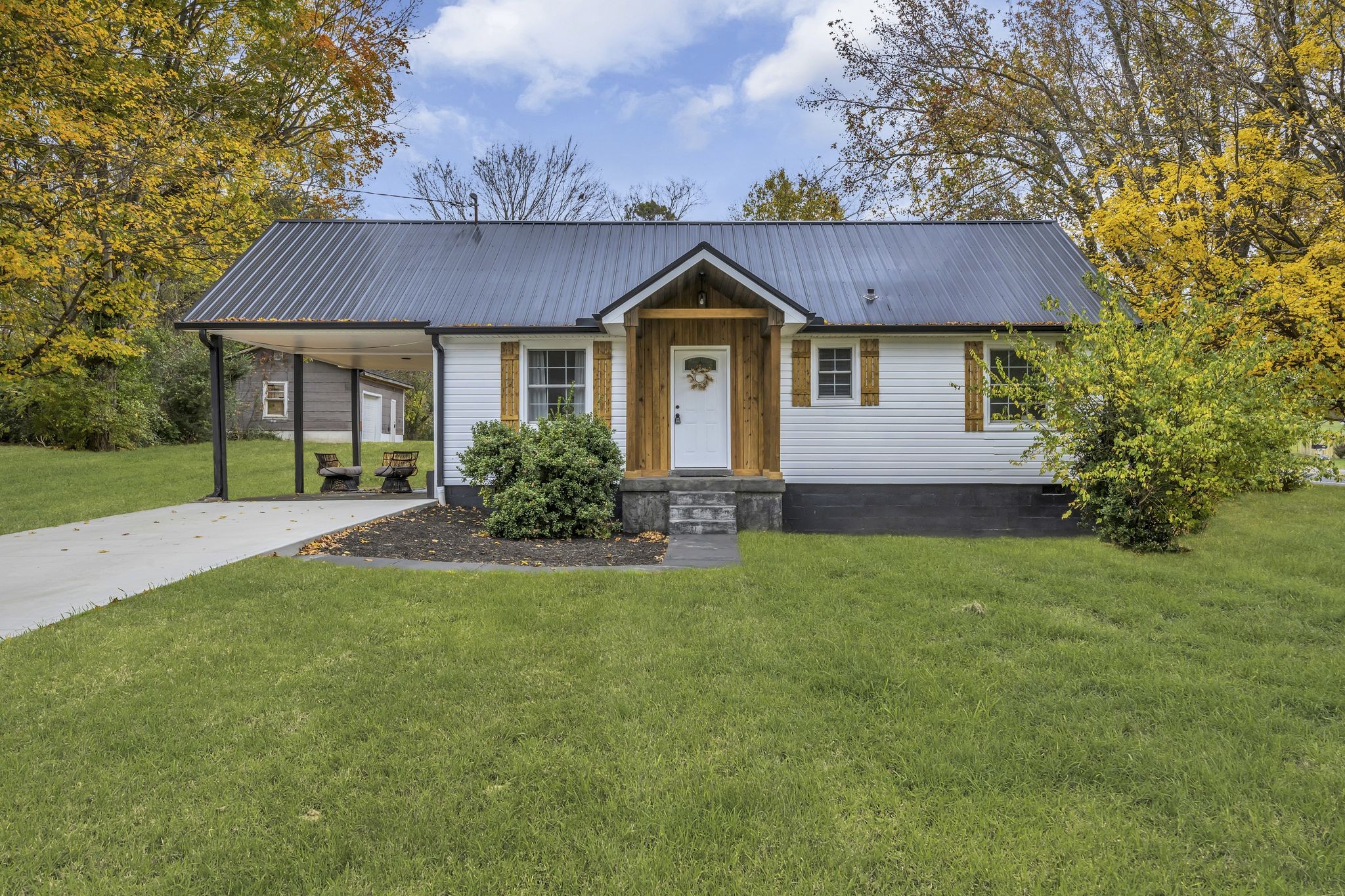 a front view of a house with yard and green space