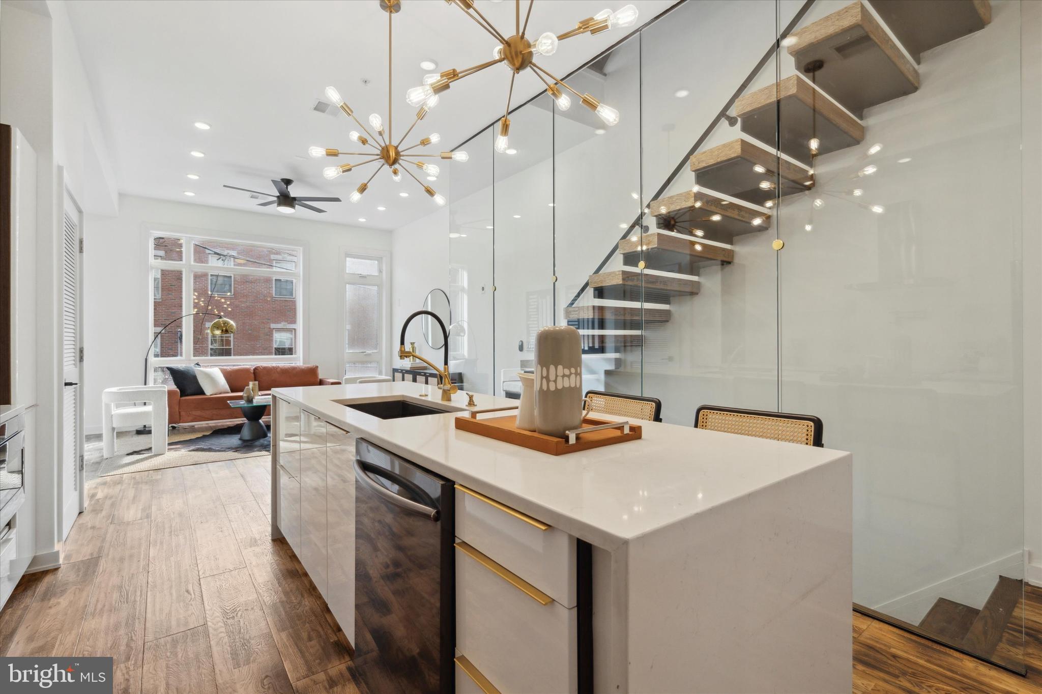 a kitchen with sink a stove and chairs