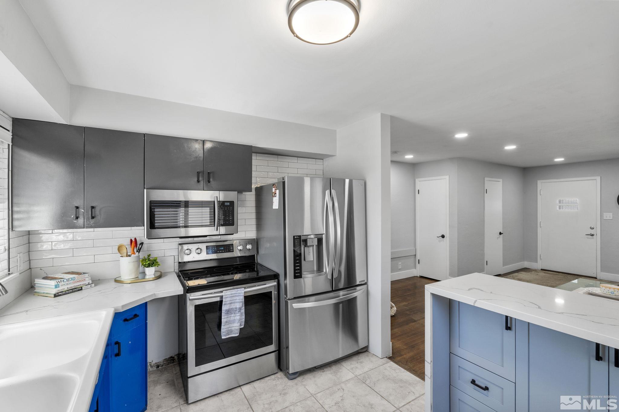 a kitchen with stainless steel appliances a refrigerator stove and sink