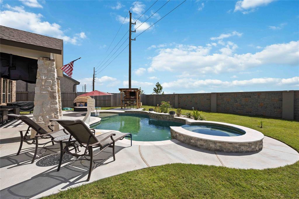 a swimming pool with outdoor seating and yard