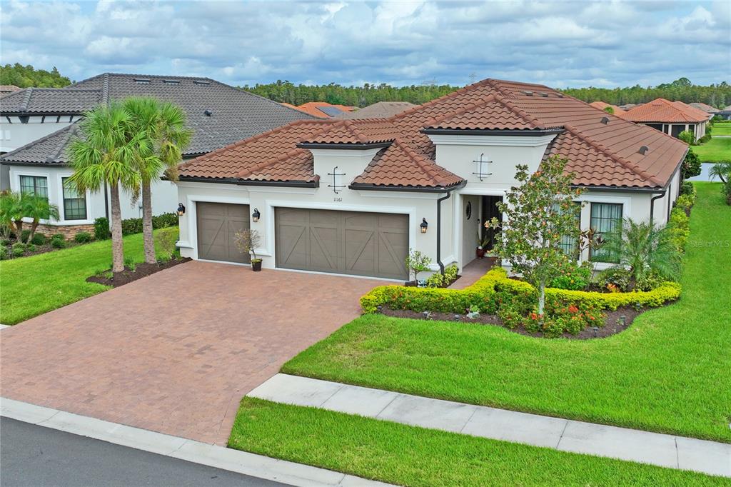 a front view of a house with a yard and garage