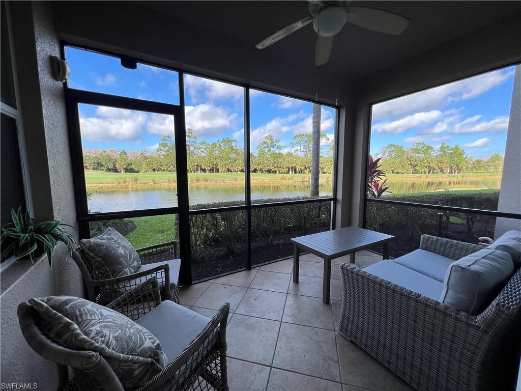 a living room with large windows and a flat screen tv