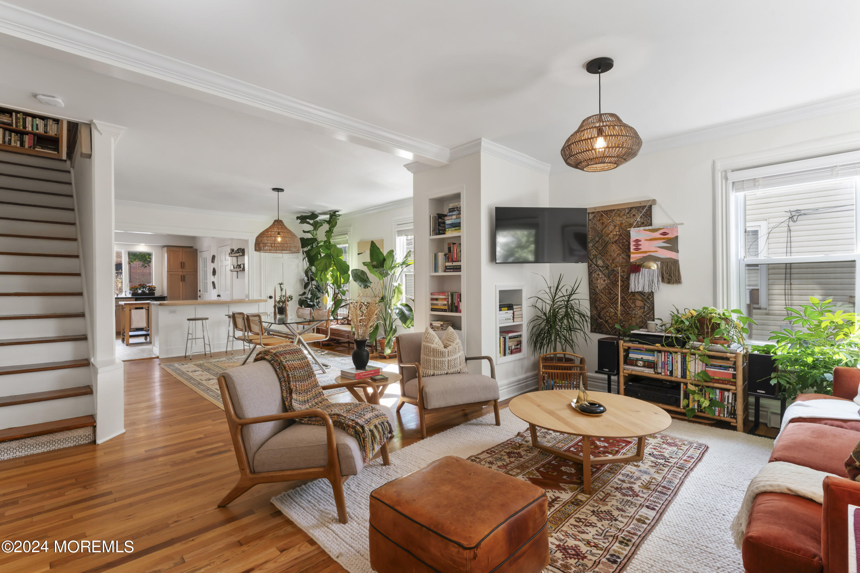 a living room with furniture kitchen view and a window