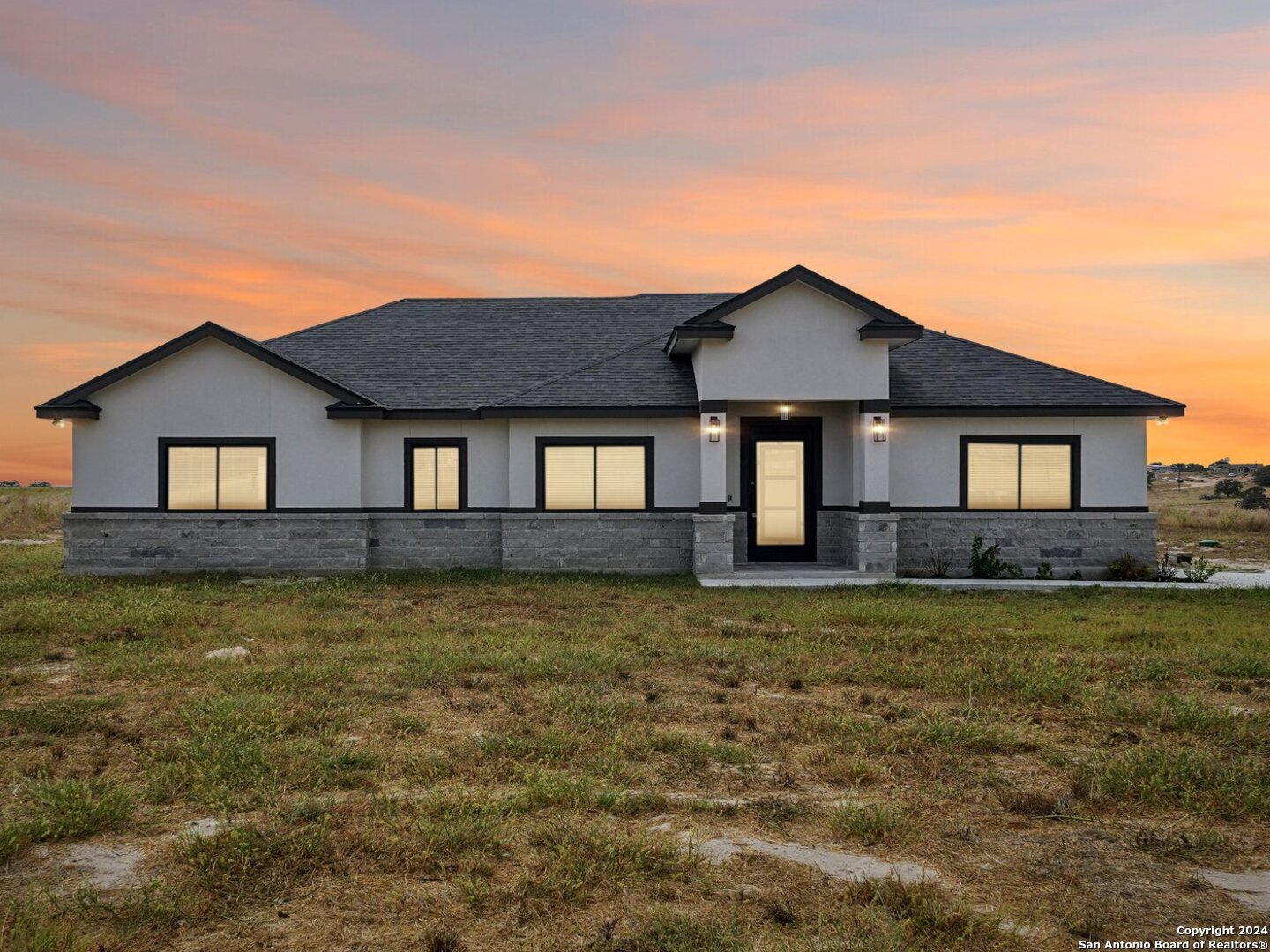 a front view of a house with a yard