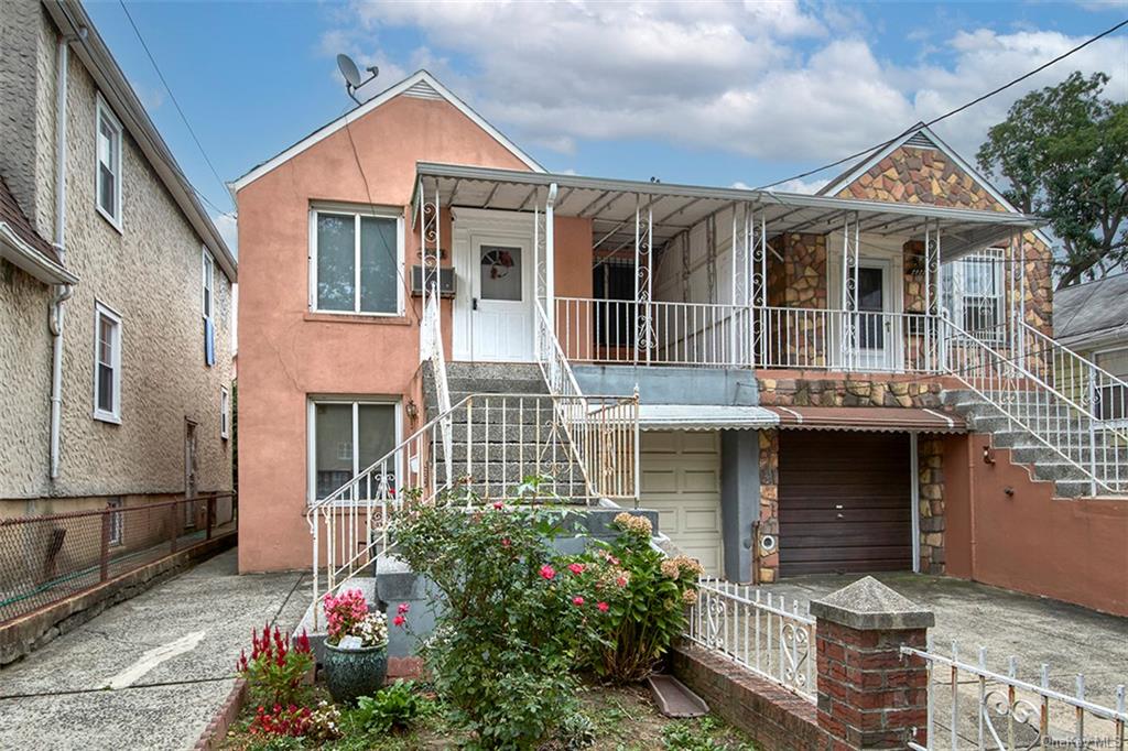 View of front of property with covered porch and a garage