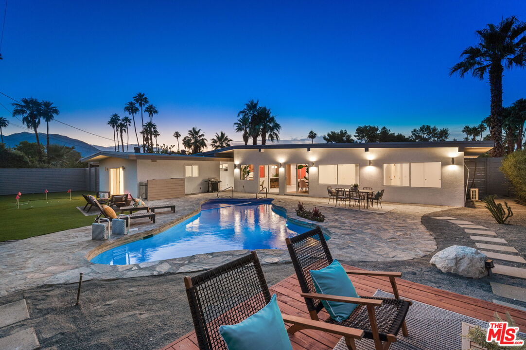 a view of a swimming pool with lounge chairs