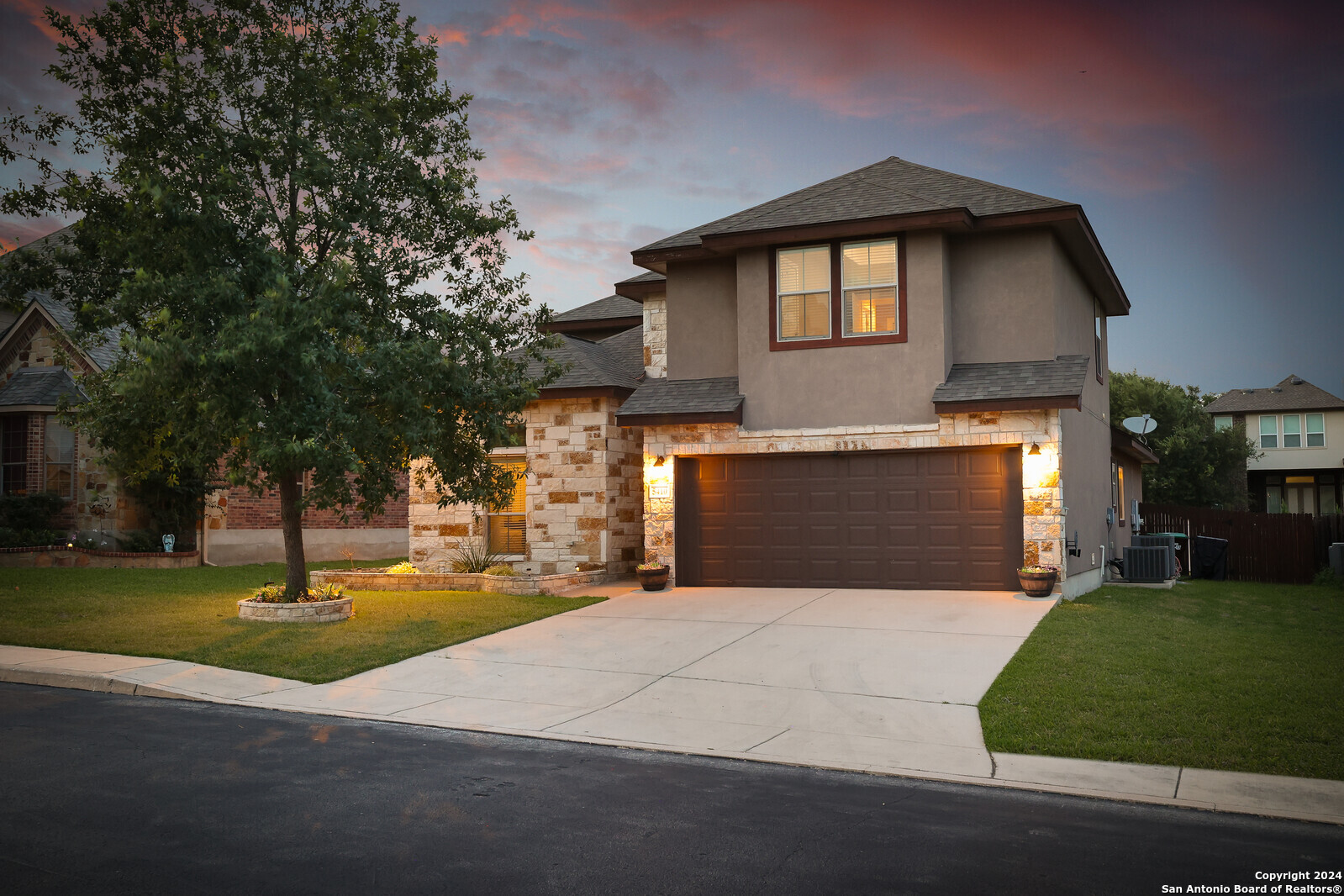 a front view of a house with a yard and garage