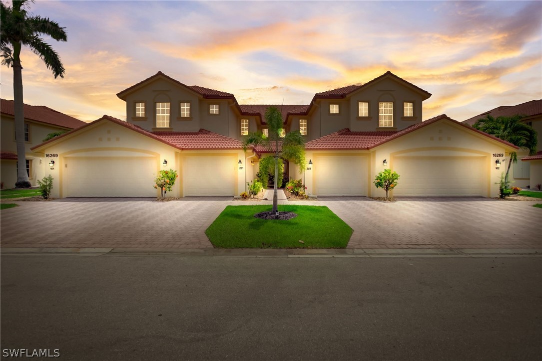 a front view of a house with a yard and garage