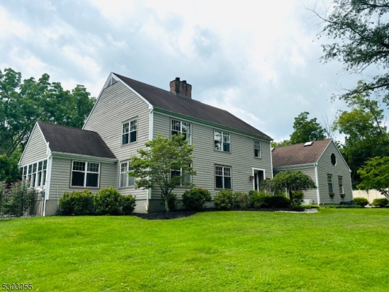 a front view of house with a garden