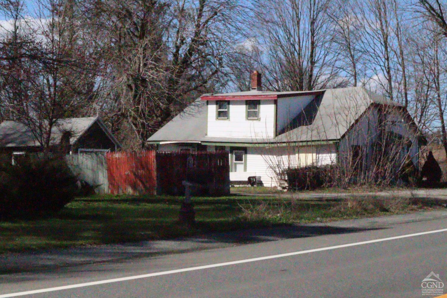 a house that has a tree in front of it