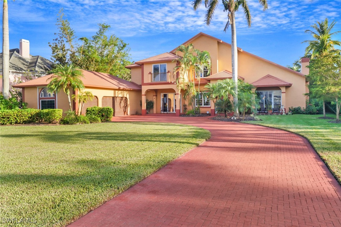 a front view of a house with a garden and yard