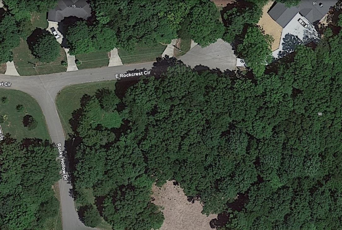 an aerial view of a house with a yard and outdoor seating