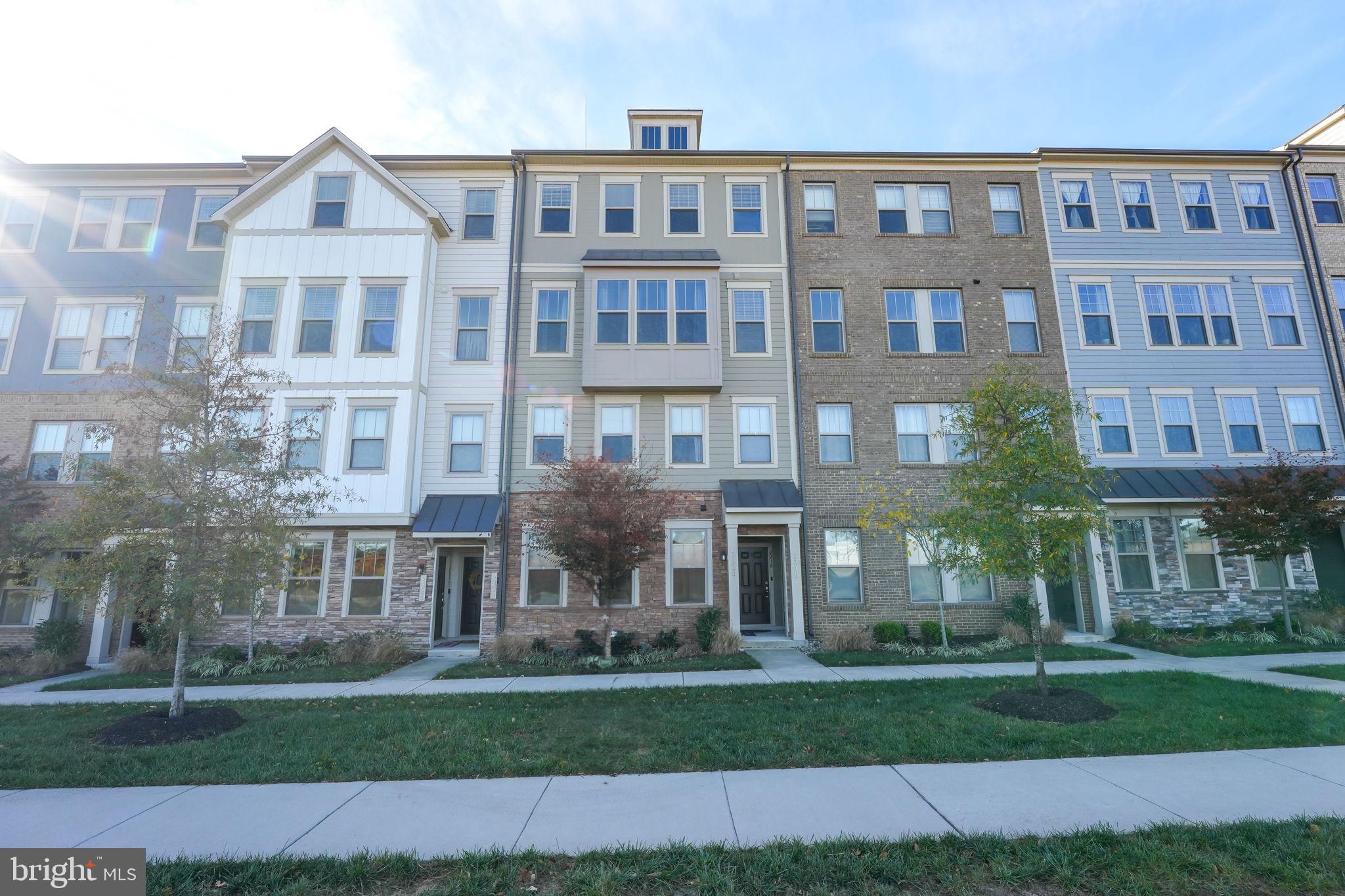 a front view of a residential apartment building with a yard