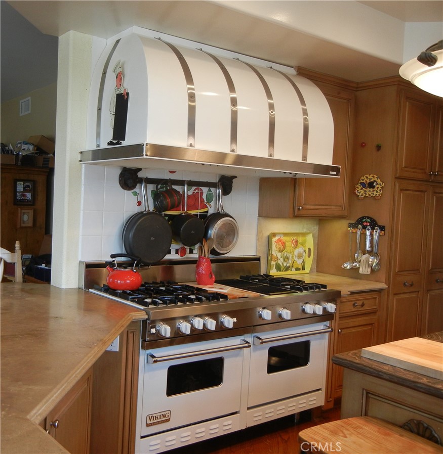 a stove top oven sitting inside of a kitchen