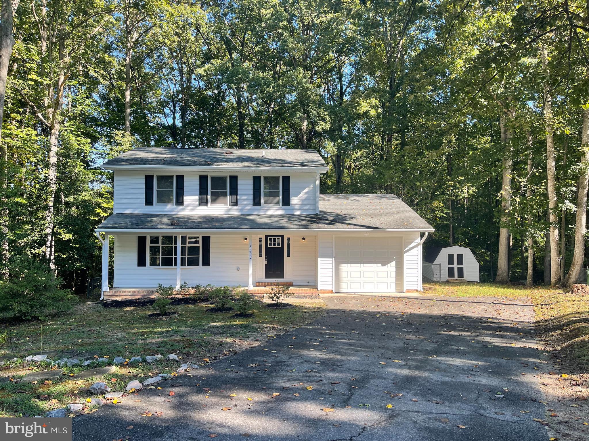 a view of a house with a backyard