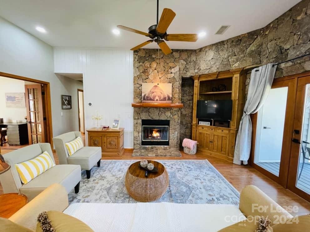 a living room with furniture a fireplace and a flat screen tv