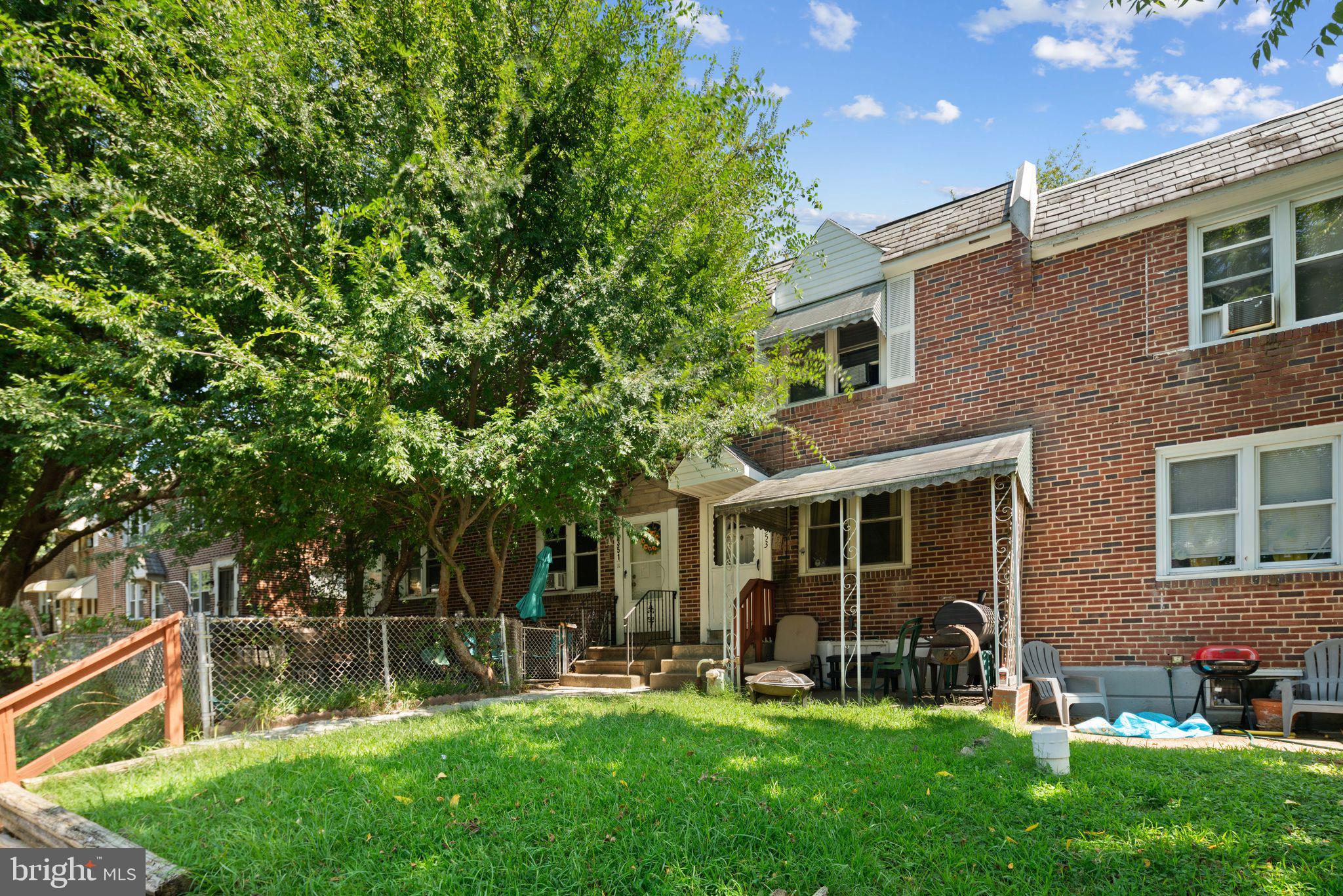 front view of a house with a yard and sitting area