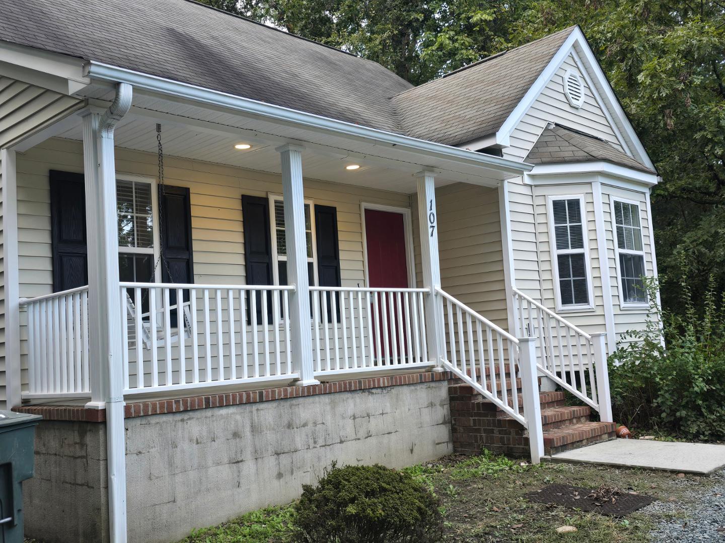 a view of a brick house with a small yard