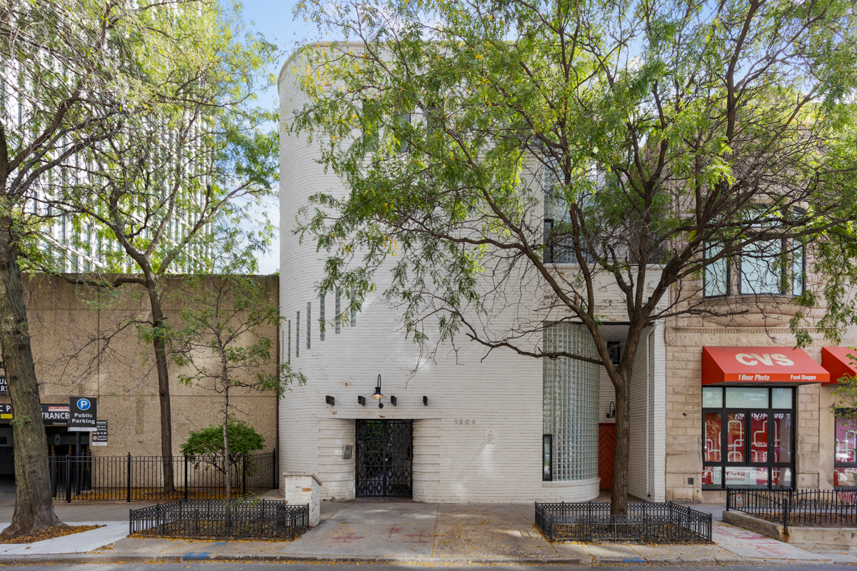 a front view of a building with tree s