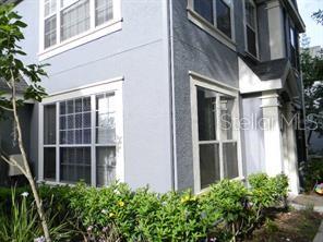 a view of a building with a large window and potted plants