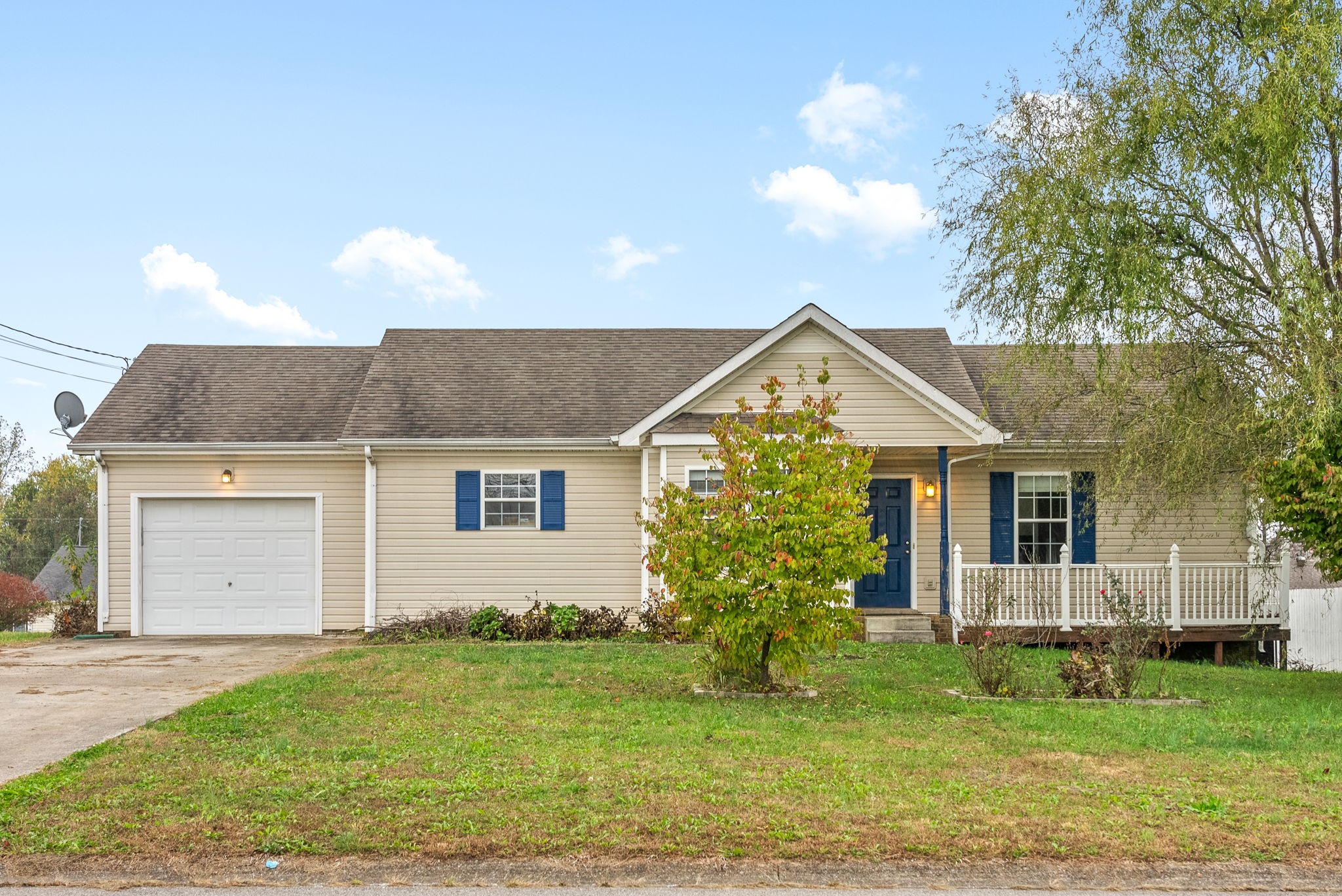 a front view of house with yard and green space