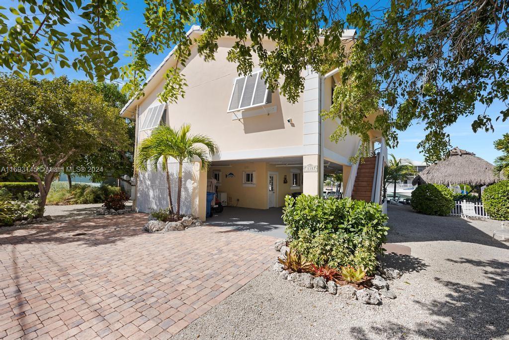 a front view of a house with a yard and a garage