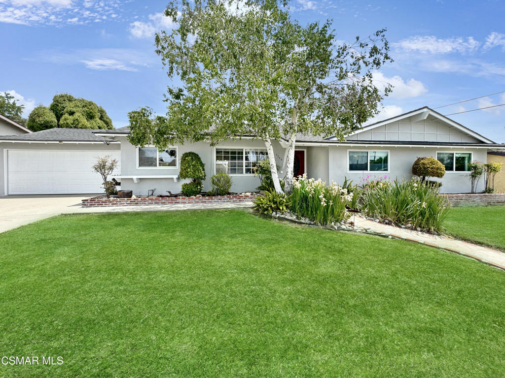 a front view of house with yard and outdoor seating